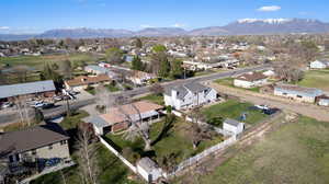 Aerial perspective of suburban area featuring a mountainous background