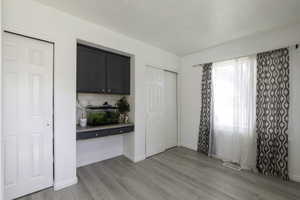 Unfurnished dining area with light wood-type flooring and baseboards