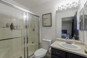 Bathroom with vanity, connected bathroom, and a shower stall