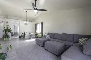 Living room with ceiling fan, wood finished floors, lofted ceiling, and suspended lighting