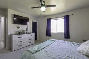 Bedroom featuring ceiling fan and light colored carpet