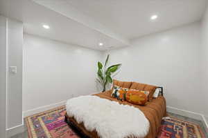 Carpeted bedroom with recessed lighting