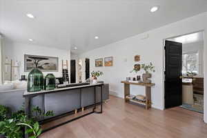 Living area featuring light wood-type flooring and recessed lighting