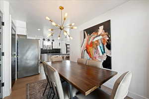 Dining space with hanging lights and wood finished floors
