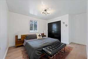 Bedroom with light wood-style floors and a closet