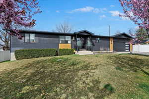 View of front of property featuring an attached garage and driveway