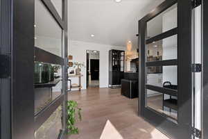 Living room with light wood finished floors and recessed lighting
