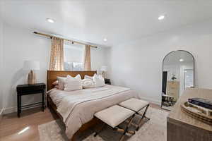 Bedroom with light wood-type flooring and recessed lighting