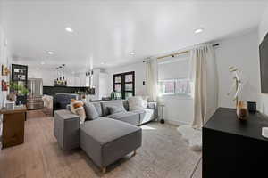 Living area with recessed lighting and light wood-style flooring
