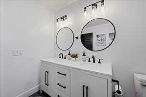 Bathroom with double vanity and toilet