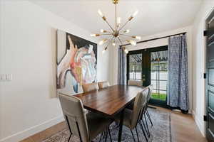 Dining room featuring light wood finished floors and hanging lights