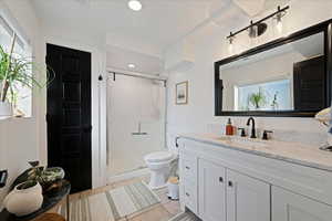 Full bath featuring vanity, a shower stall, light tile patterned floors, and recessed lighting