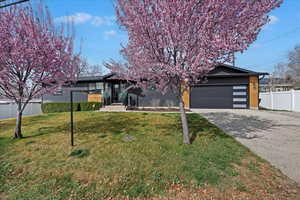 Obstructed view of property featuring concrete driveway and an attached garage