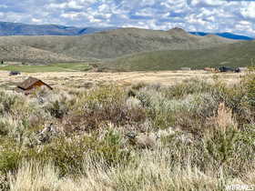 View of mountain backdrop featuring rural landscape