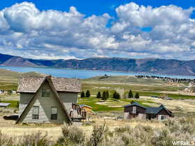 View of mountain background with rural landscape and a nearby body of water