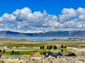 View of mountain background with a large body of water and rural landscape