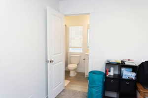 Bedroom with en suite bathroom with toilet and vanity