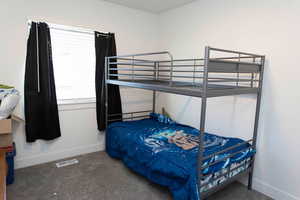 Carpeted bedroom with baseboards