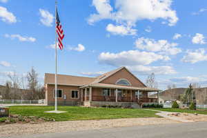 View of front facade featuring covered porch and stucco siding