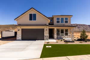 View of front facade featuring a mountain view, stone siding, concrete driveway, and a garage