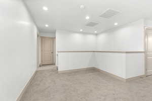 Unfurnished room featuring light colored carpet and recessed lighting