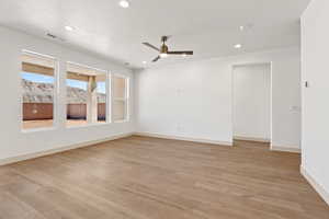 Empty room featuring a ceiling fan, light wood-style floors, and recessed lighting