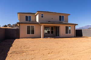 Rear view of house with a patio, a fenced backyard, and stucco siding