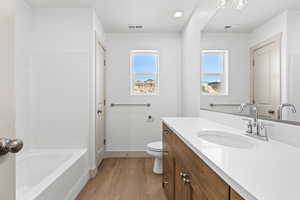 Full bathroom with vanity and light wood-type flooring