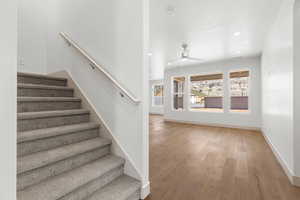 Stairway featuring recessed lighting, wood-type flooring, and a ceiling fan