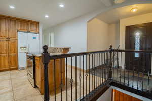 Corridor featuring recessed lighting and arched walkways