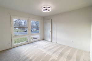 Spare room featuring light carpet