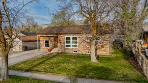 View of front of house with stone siding and roof with shingles
