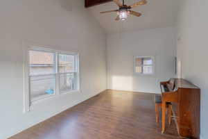 Unfurnished room with ceiling fan, dark wood-style flooring, and lofted ceiling