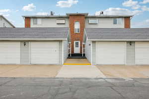 Traditional-style home with a shingled roof