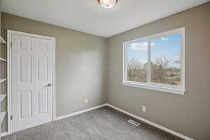 Unfurnished bedroom featuring carpet and baseboards