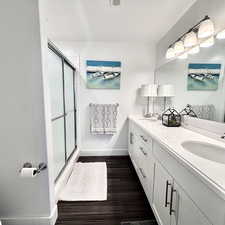 Well-appointed primary ensuite bath with double vanity, abundant storage, and a spacious & convenient walk-in shower.