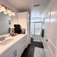 Bright bathroom #1 featuring a large vanity, generous cabinetry/storage, and a clean, modern feel.