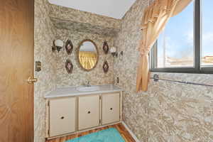 Bathroom featuring vanity and light wood-style flooring