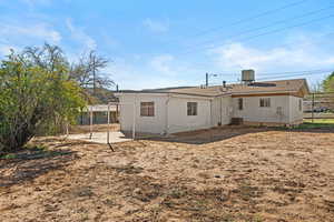 Back of property with a patio and roof with shingles