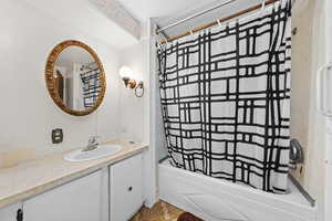 Bathroom with vanity and shower / bath combo with shower curtain