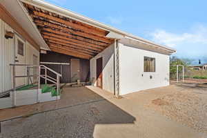 Back of house featuring stucco siding