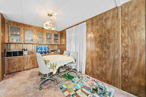 Office with carpet floors and wooden walls