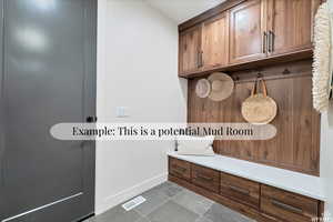 Mudroom with dark tile patterned floors and baseboards