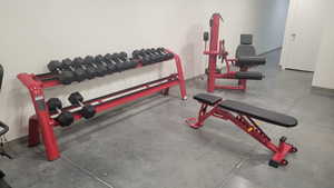 Exercise area featuring finished concrete flooring and baseboards