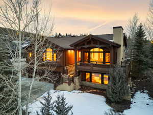 View of front of home featuring a chimney and a wooden deck
