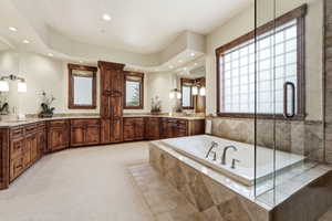 Full bathroom featuring light carpet, vanity, a garden tub, a shower stall, and recessed lighting