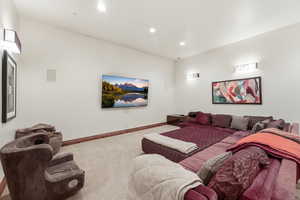 Carpeted home theater with baseboards and recessed lighting