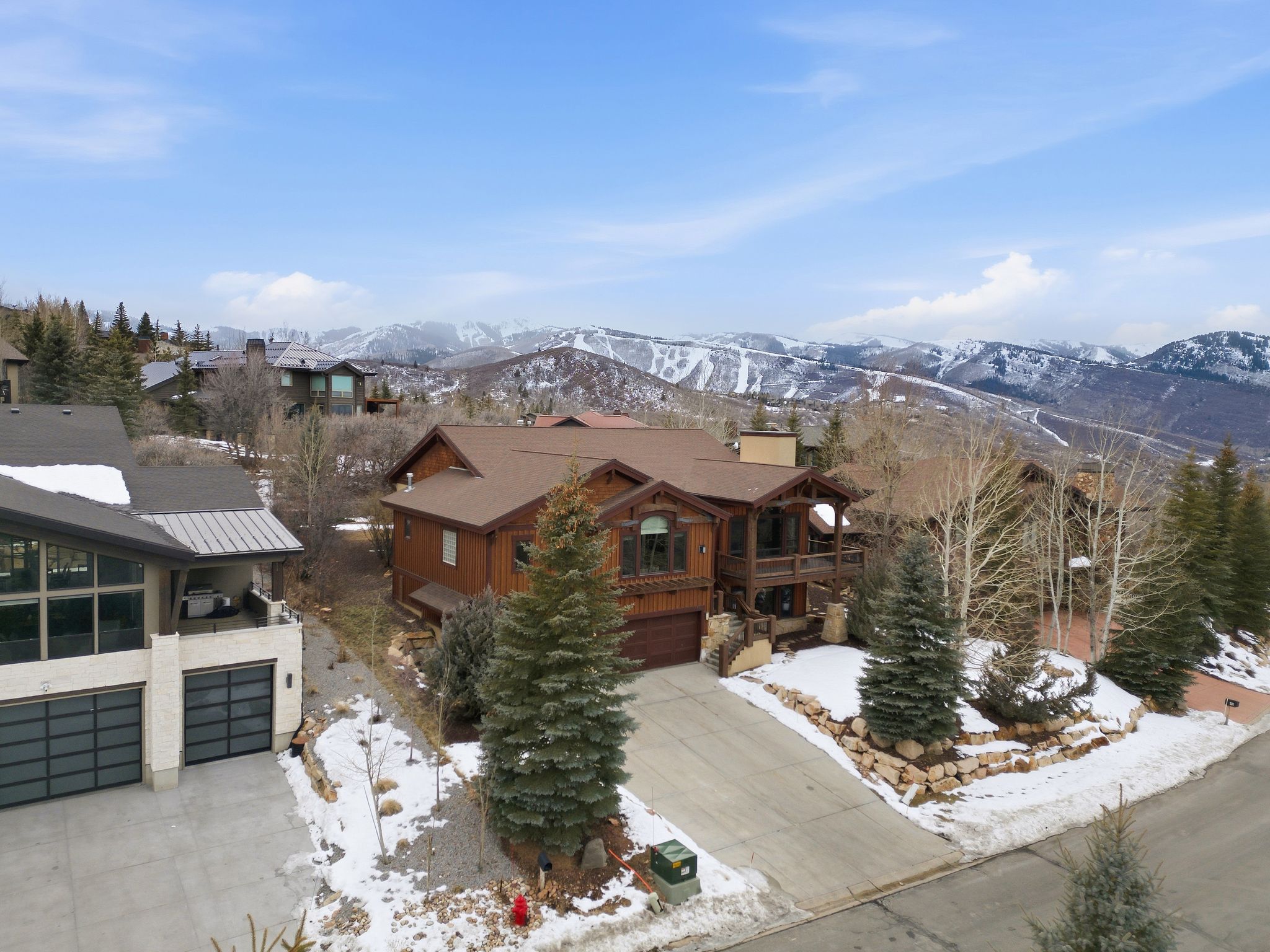 View of front facade featuring concrete driveway, an attached garage, a mountain view, and a balcony
