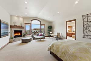 Bedroom with a tile fireplace, carpet flooring, ensuite bath, and recessed lighting