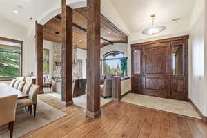 Foyer entrance featuring lofted ceiling and light wood-style flooring